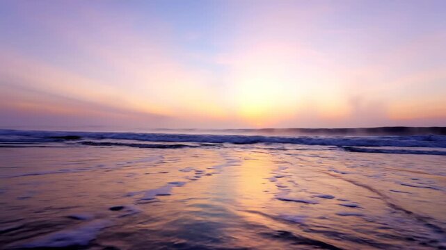 Serene beach scene at sunrise with gentle waves lapping against the shore, reflecting vibrant colors of the sky and creating a tranquil coastal atmosphere
