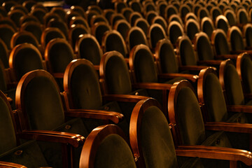 Empty Classic Theater Auditorium with Rows of Velvet Seats and Wooden Armrests