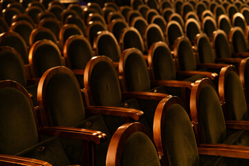Fototapeta premium Empty Classic Theater Auditorium with Rows of Velvet Seats and Wooden Armrests