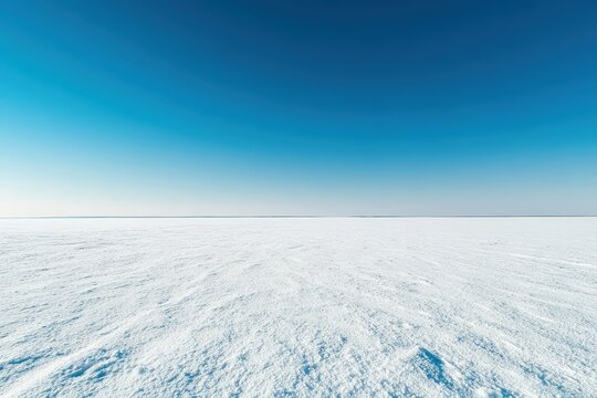 Wide expanse of pristine snow under a brilliant blue sky.