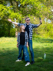 Happy Father And Daughter Taking A Selfie Outdoors In Summer