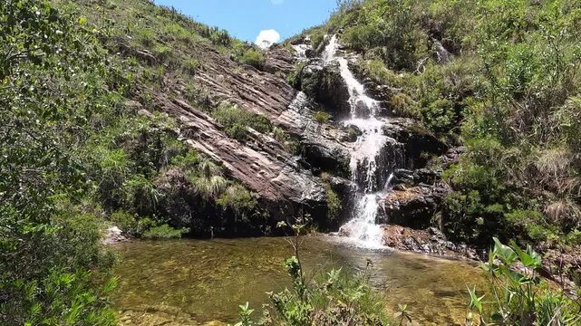 Serra do Cip&oacute; Waterfall on a Beautiful Clear Sky Day with White Clouds