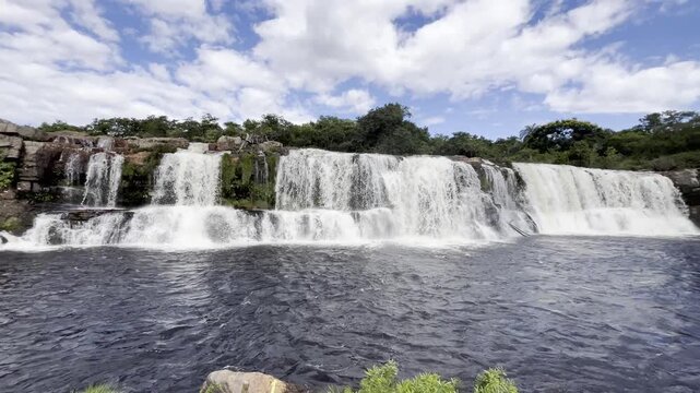 Serra do Cip&oacute; Waterfall on a Beautiful Clear Sky Day with White Clouds