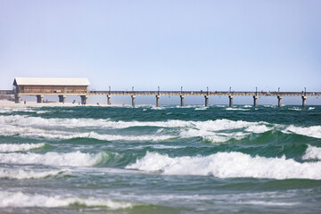 Gulf Shores Offers Beach Scenes With Waves, a Pier, and Visitors on a Sunny Day Near the Alabama Coast