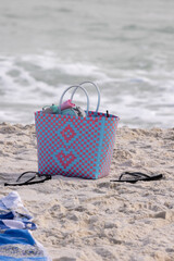 Beach Bag and Flip Flops on Sand at Gulf Shores, Alabama With Waves in the Background During a Sunny Afternoon