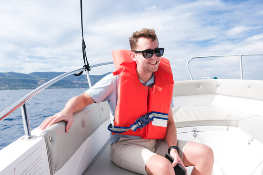 Enjoying a Sunny Day on a Boat With a Life Jacket in the Ocean