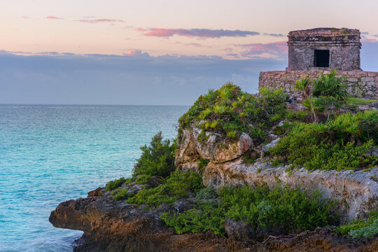 Mayan temple at sunset on tulum cliffs overlooking caribbean sea