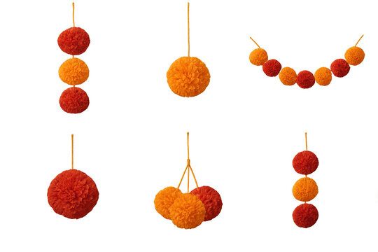 Soft red and orange yarn pom pom ornaments and garlands hanging against a transparent background