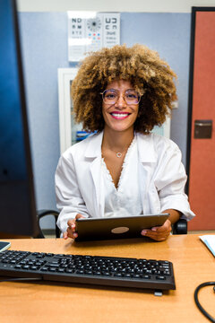 Optometrist woman working with digital tablet in office