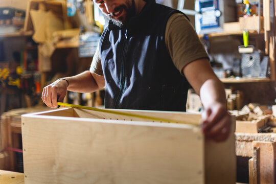 Crafting a wooden box in a workshop with careful measurements