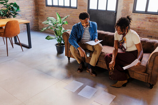 Coworkers collaborating on business plan in modern office