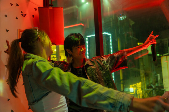 Two Friends Enjoying a Lively Night out in the City Lights