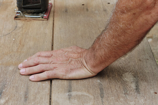 Senior male hand working on wood