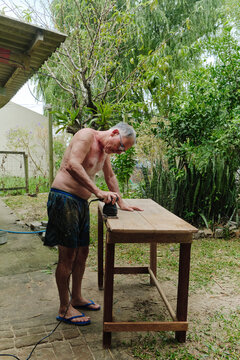 Senior man working on a wooden table in nature