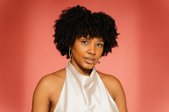 Fashionable woman stands in a studio setting