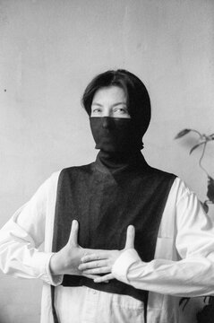
portrait of a woman with her face half covered