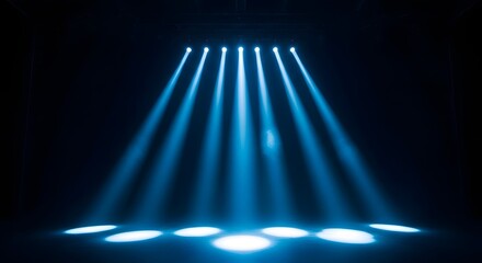 Obraz premium Concert stage lighting with blue beams and spotlights