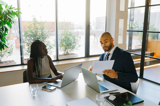 Business professionals having formal meeting in office