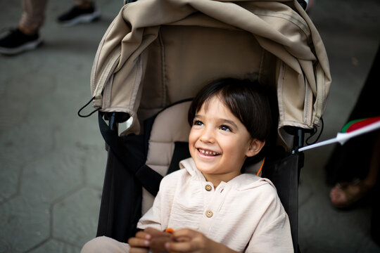 Cheerful child in baby stroller 