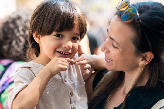 Tender portrait holding cheerful toddler
