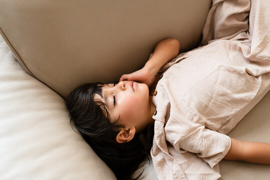 Young child peacefully sleeping on sofa