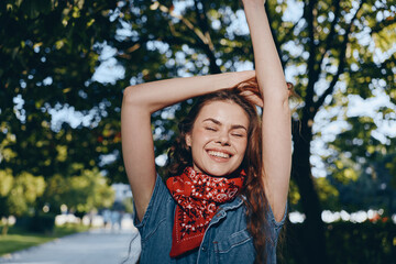 lifestyle woman in modern boho-western denim street style with red bandana smiling outdoors, film...