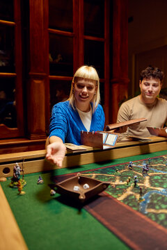 Woman rolls dice during the game