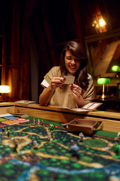 Woman smiles while playing a board game