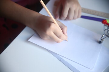 close up of hand writing on a paper