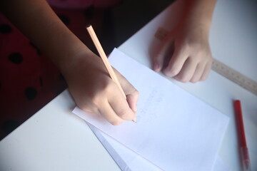 close up of hand writing on paper