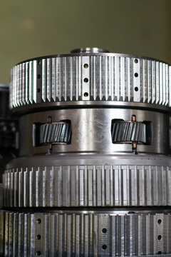 Close-up of a professional steel planetary gear set from an Allison transmission, showing the precision teeth and metallic texture during a heavy-duty gearbox maintenance in a workshop.