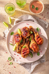 Hot roasted chicken leg made on a metal grill.