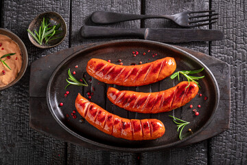 Hot grilled sausage with mustard sauce and rosemary.
