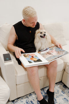 A guy with a dog on the couch