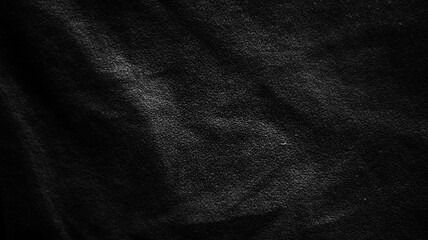 Close up of dark black fabric texture with soft natural folds and subtle shadows. Elegant textile...
