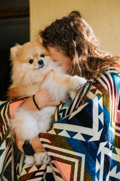 Dog Cuddles Bring Joy in a Cozy Home Setting