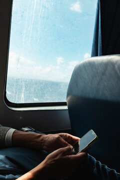 Hands Holding Phone on Ferry