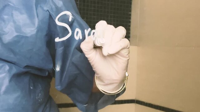 unrecognisable female hand writing concept meaning measles in Spanish sarampion virus researcher studying in medical lab