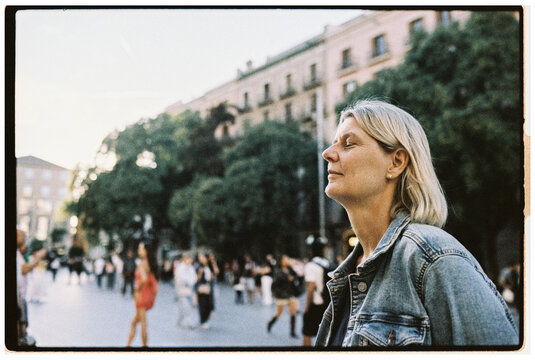Woman Enjoying a Peaceful Moment in a Lively Public Square