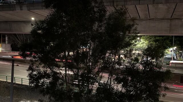 Elevated road urban freeway traffic motion blur at night in Mexico, lock down camera Time - Lapsed