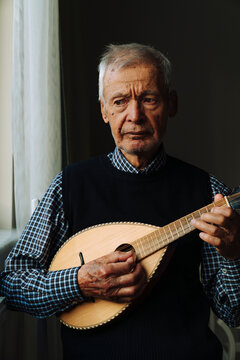 Senior man playing a mandolin