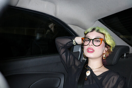 By app taxi to the party Sitting in Car at Night