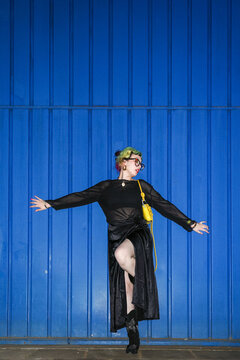 Pose Against Vibrant Blue Wall at night direct flash