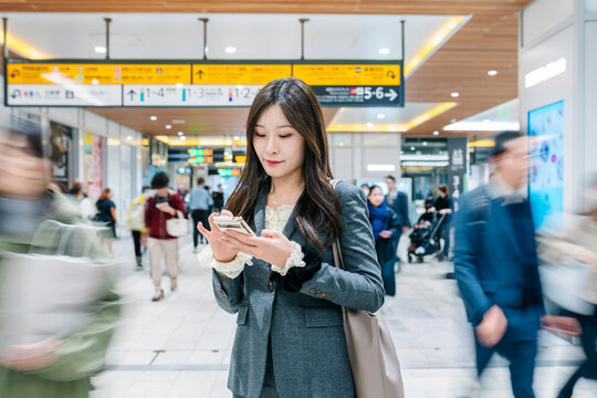 Japanese woman commuting in busy Tokyo subway station