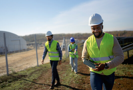 Construction workers checking progress on a solar farm