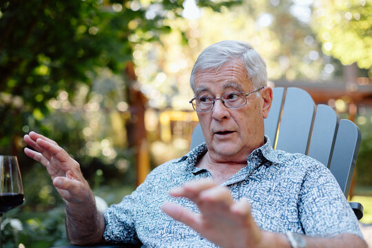 Candid older man in patterned shirt shares a moment outdoors