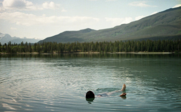 Woman bathing on Edith Lake, Jasper area, Alberta.