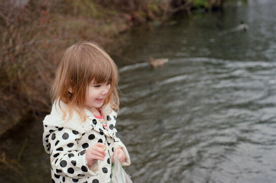 Child smiling by pond