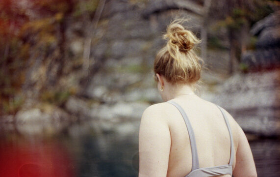 Woman entering the water in a lake