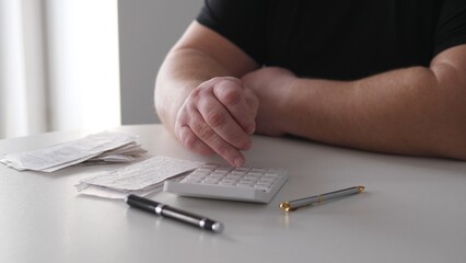 Fototapeta premium Naturallight Hands Calculating Invoices On Desk, Relaxed Freelance Workflow With Receipts And Pen By Bright Window, Small Business Billing And Planning